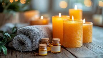 Relaxing spa setting with candles, essential oil, and towels on a wooden surface at evening time photo