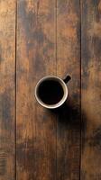 Rich black coffee served in a white cup on a rustic wooden table in a cozy setting photo