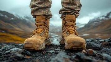 Boots stand firmly in muddy terrain during an outdoor activity in a rugged landscape photo