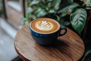 Warm latte served in a textured cup on a rustic wooden table in a cozy caf atmosphere photo
