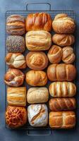 Freshly baked assorted bread rolls on display at a local bakery for customers to choose from photo