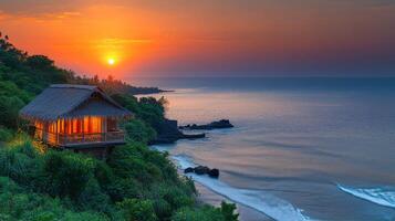Sunset illuminates beachside hut near calm waves in a serene coastal setting photo