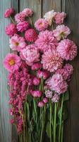 Bright pink flowers arranged artistically on a wooden background for decoration or design purposes photo