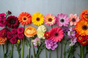 Colorful arrangement of assorted flowers on display against a light background photo