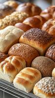 Freshly baked assorted bread rolls on display at a local bakery for customers to choose from photo