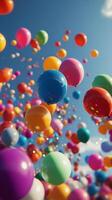 Colorful balloons float against a bright blue sky during a festive celebration in an open area photo