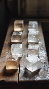 Unique arrangement of transparent and colored ice cubes in a wooden tray photo