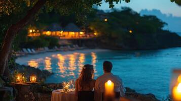 Romantic dinner setting by the beach under twinkling lights at sunset photo
