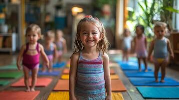 Young child practices yoga with classmates in a bright and cheerful studio during a morning class photo