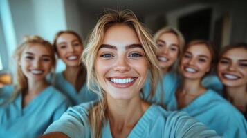 Group of smiling healthcare professionals in scrubs enjoying a moment together indoors photo