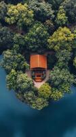 Modern cabin surrounded by lush greenery on a serene lake at dusk photo
