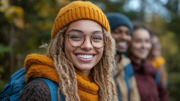 Group of friends enjoying a hike in autumn forest with smiles and cozy outfits photo