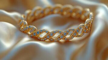Elegant gold bracelet adorned with intricate designs displayed on soft fabric photo