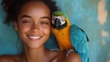 Girl smiles while holding a colorful parrot on her shoulder in a lush outdoor setting photo