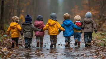 Children walking hand in hand through a flower field on a cloudy day in a rural area photo