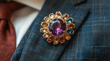 Elegant floral design brooch featuring colorful gemstones on a textured dark fabric background photo