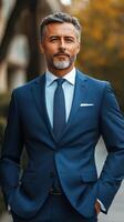 Confident man in elegant blue suit poses outside a modern building in the city photo