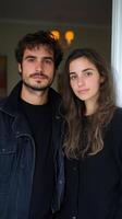 Couple poses together in a cozy indoor setting during a relaxed afternoon photo