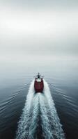 Large cargo ship navigating through calm ocean waters during sunset photo