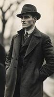 Stylish man in a dark coat and hat confidently poses outdoors in a vintage black and white setting photo