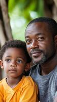 Father and son enjoying a moment outdoors in a lush green setting photo