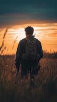 Soldier standing in a field during a sunny afternoon, contemplating the vast open landscape photo