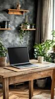 Cozy workspace with laptop by window surrounded by greenery on a sunny autumn morning photo