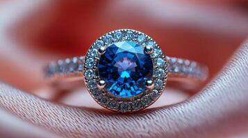 Elegant gold ring featuring a stunning blue gemstone on a soft fabric background photo