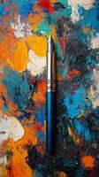 Colorful paint palette with a fountain pen resting on the vibrant textures photo