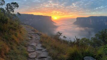 Stunning sunrise over a lush valley with mountains in the background and mist rising from the ground photo