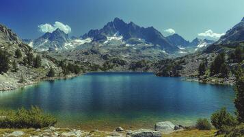 Majestic mountain landscape reflected in calm lake under a clear blue sky with fluffy clouds photo
