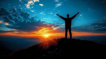 Individual celebrating a stunning sunset view from a hilltop with outstretched arms photo