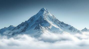 Majestic snowy mountain peak rises above the clouds in clear sky during bright daylight photo