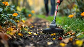 Gardener trims grass along a stone pathway in a vibrant garden during springtime photo