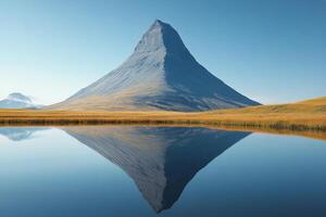 Majestic snowy peak reflecting in tranquil lake under clear blue sky photo