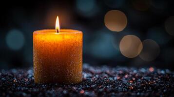 Warm glow of a candle illuminating a dark space with soft bokeh background photo
