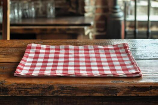 Red and white checkered tablecloth on rustic wood surface creates a cozy dining atmosphere photo