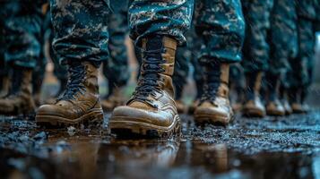Soldiers marching through a muddy trail in a dense forest during a training exercise photo