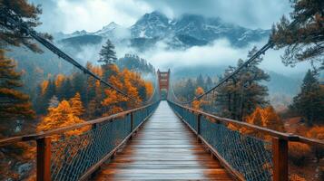 Stunning bridge stretches across misty valley with autumn colors and mountains in the background photo