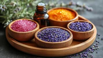 Aromatherapy essential oils displayed on wooden tray with dried lavender and candles in cozy setting photo