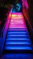Staircase illuminated by vibrant neon lights in a modern urban setting photo