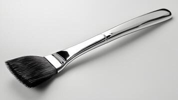 Polished stainless steel spoon resting on a light surface with a reflective finish at midday photo