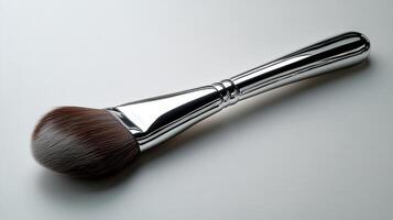 Polished stainless steel spoon resting on a light surface with a reflective finish at midday photo