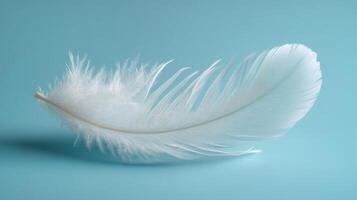 Delicate feather resting on soft blue fabric in tranquil natural light photo