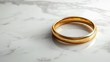 Golden ring resting on textured surface with soft light illuminating its polished finish photo