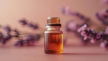 Essential oil bottle surrounded by lavender flowers on a soft pink background photo