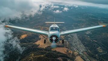 Unique aerial view of a vintage aircraft flying over scenic landscape with clouds and mountains photo