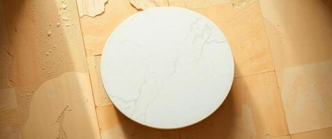 round marble table on textured yellow surface photo