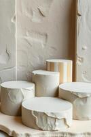 five cylindrical display stands on a textured surface photo