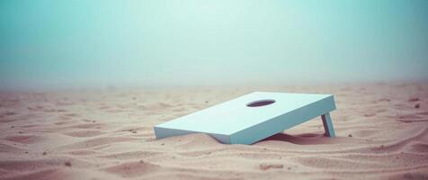 light blue game board sits the sand on a hazy beach. photo